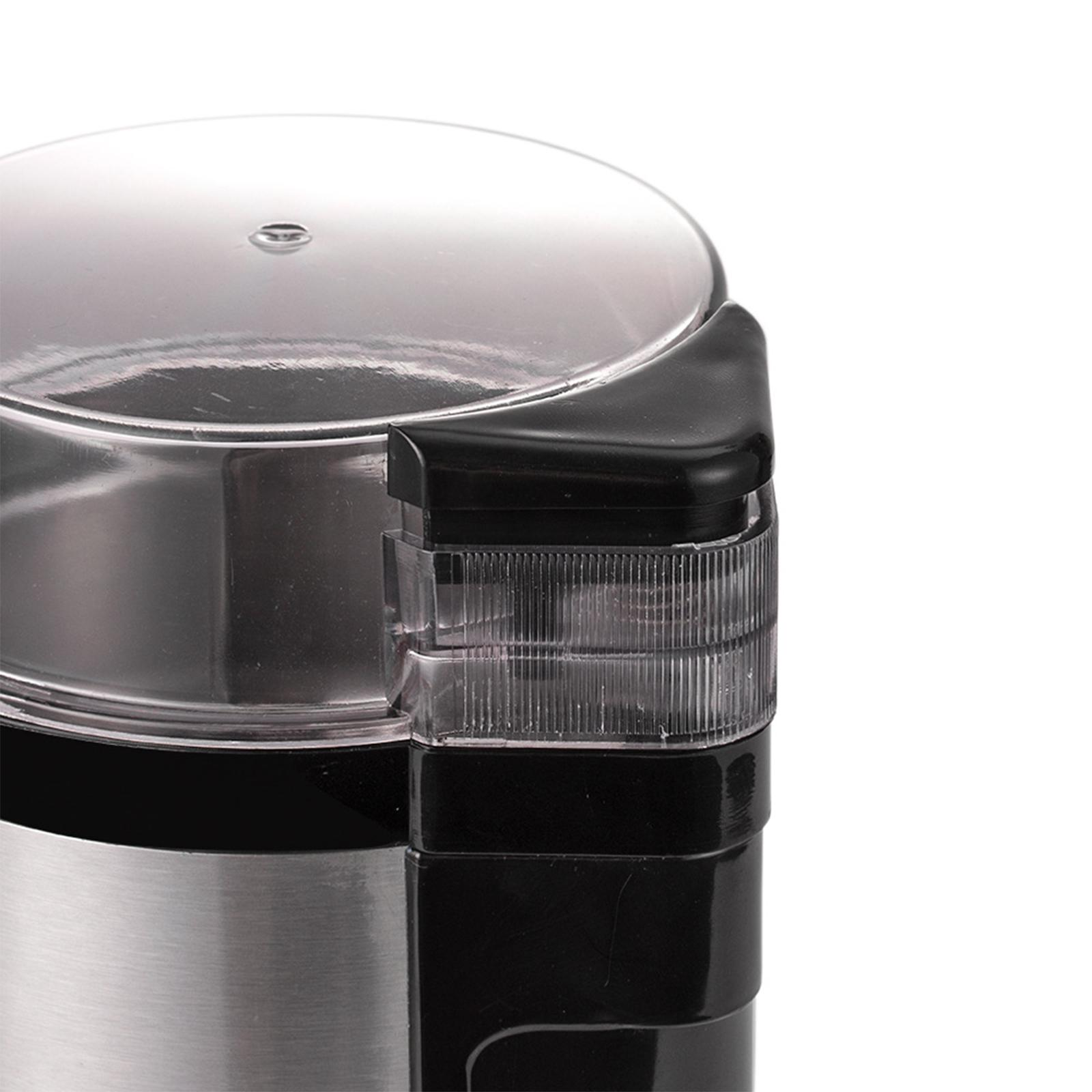 Nahaufnahme einer Kaffeemühle mit transparentem Deckel, glänzendem Edelstahlgehäuse und schwarzen Akzenten.