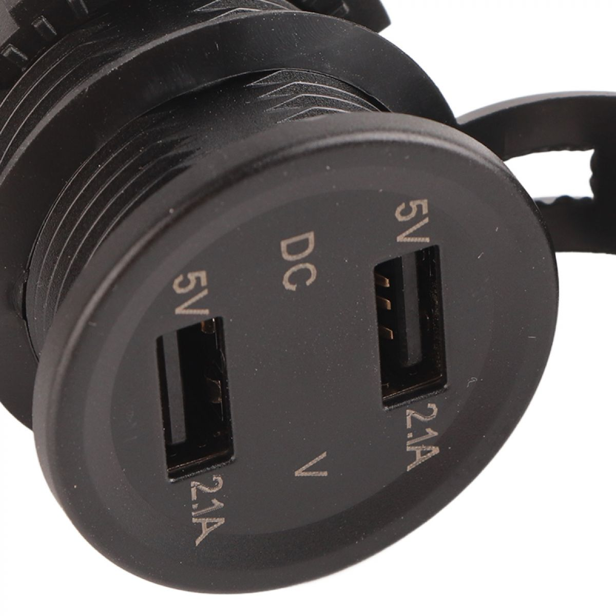 Eine Nahaufnahme eines schwarzen USB-Ladegeräts mit zwei 5V/2.1A-Anschlüssen, das seine strukturierte Oberfläche zeigt.