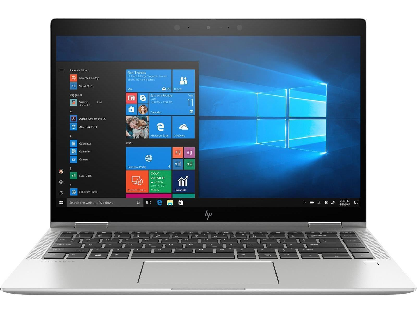 Ein silberner Laptop, der geöffnet ist und Windows zeigt. Der Bildschirm zeigt ein blaues Fensterdesign.