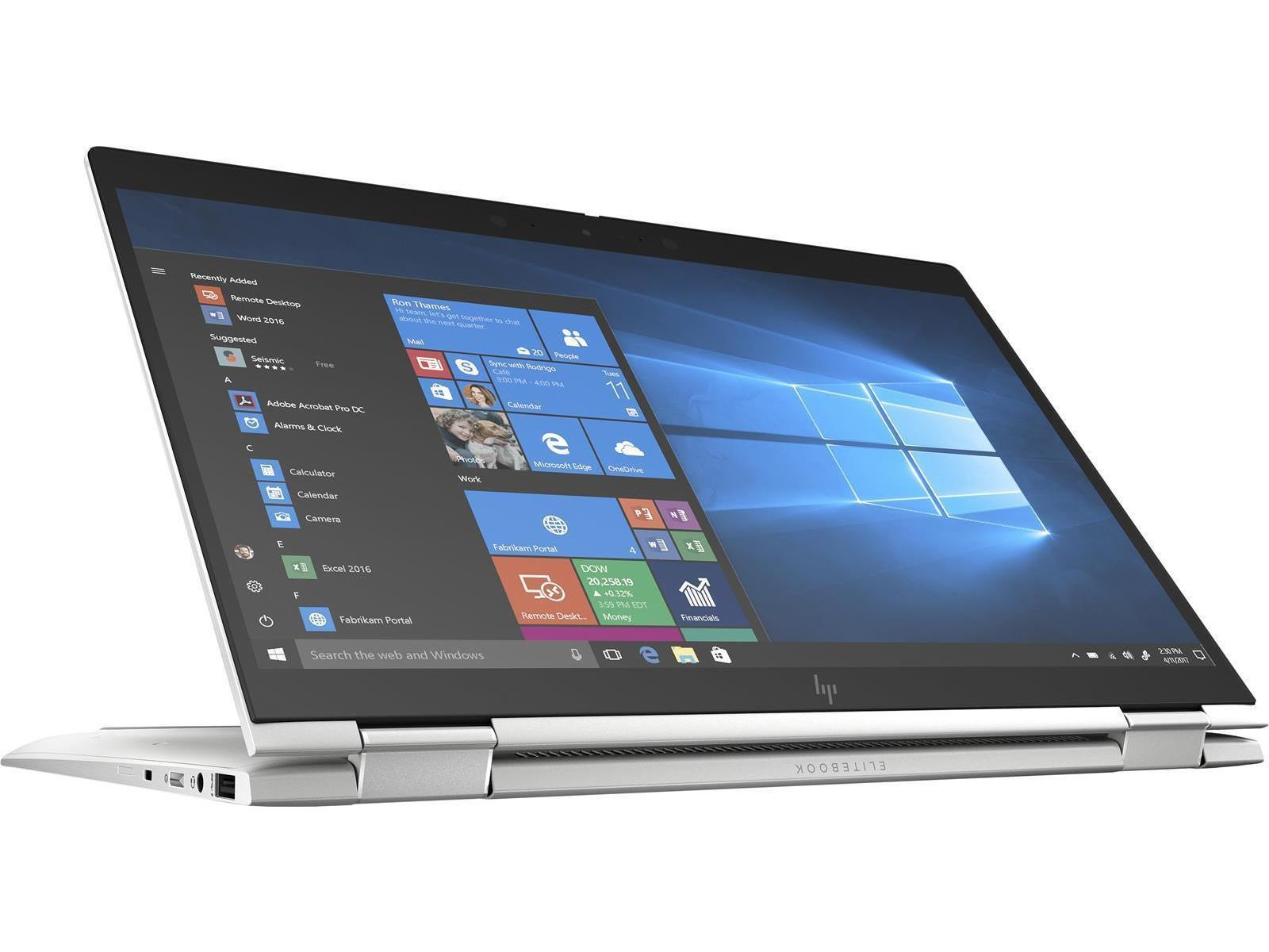 Ein silberner Laptop, der geöffnet ist und Windows zeigt. Der Bildschirm zeigt ein blaues Fensterdesign.