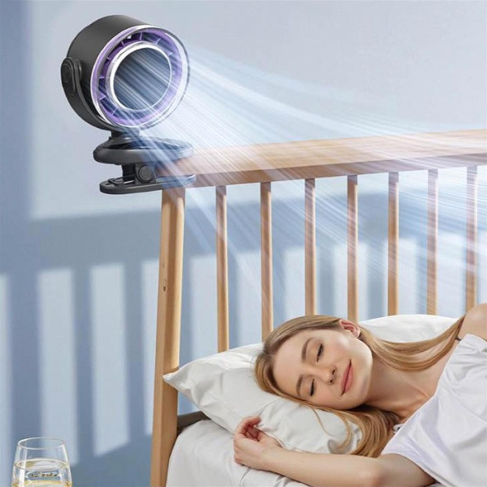 Eine Frau schläft im Bett, mit einem am Kopfteil befestigten Ventilator, der Luft in ihr Gesicht bläst.