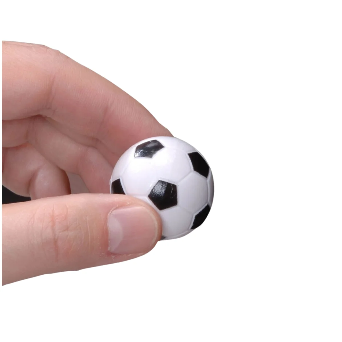 A small soccer ball, white with black pentagons, held in a hand. Background is plain white.
