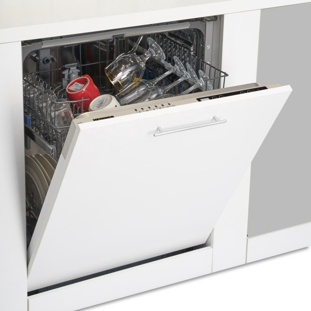 A white dishwasher with the door open. Inside, there are glasses and dishes.