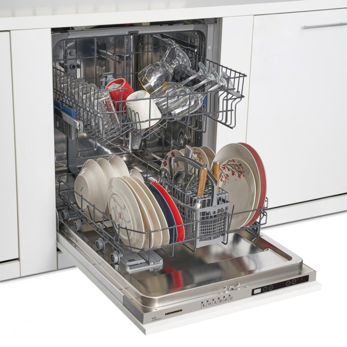 A white dishwasher with the door open, filled with dishes, glasses, and utensils.