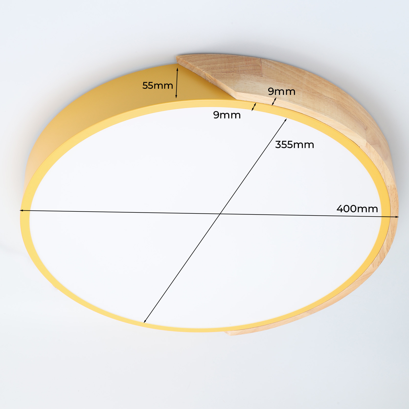 Primer plano de una luz de techo amarilla con medidas. La luz tiene un centro blanco y detalles de madera.