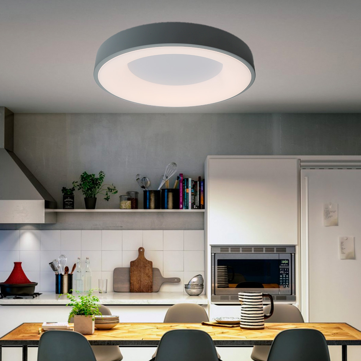 Una lámpara de techo redonda con marco gris e interior blanco, en un entorno de cocina con mesa.