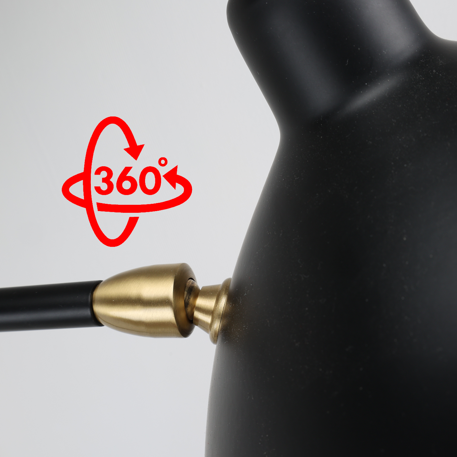 Primer plano de un cabezal de lámpara negro y una articulación dorada. Un icono rojo de 360 grados en el fondo.