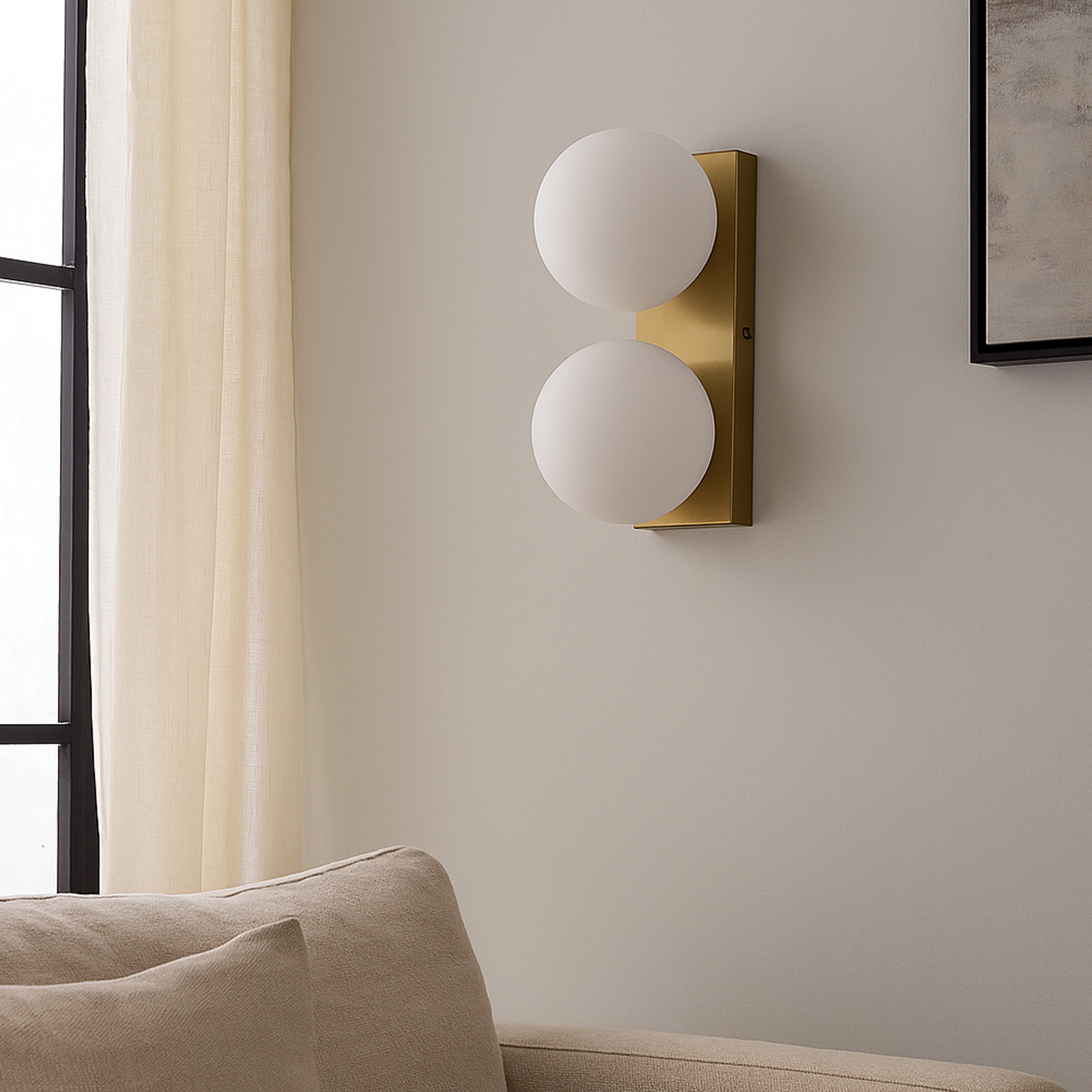 Dos bombillas redondas y blancas alineadas verticalmente en un soporte de pared rectangular dorado, con fondo beige.