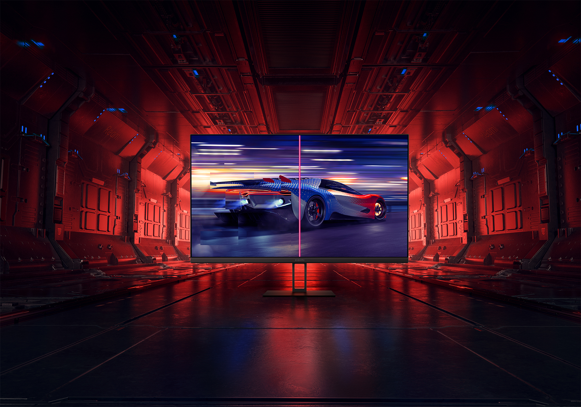 Monitor wyświetlający scenę wyścigu samochodowego, oprawioną w futurystyczną, czerwoną scenerię tunelu.