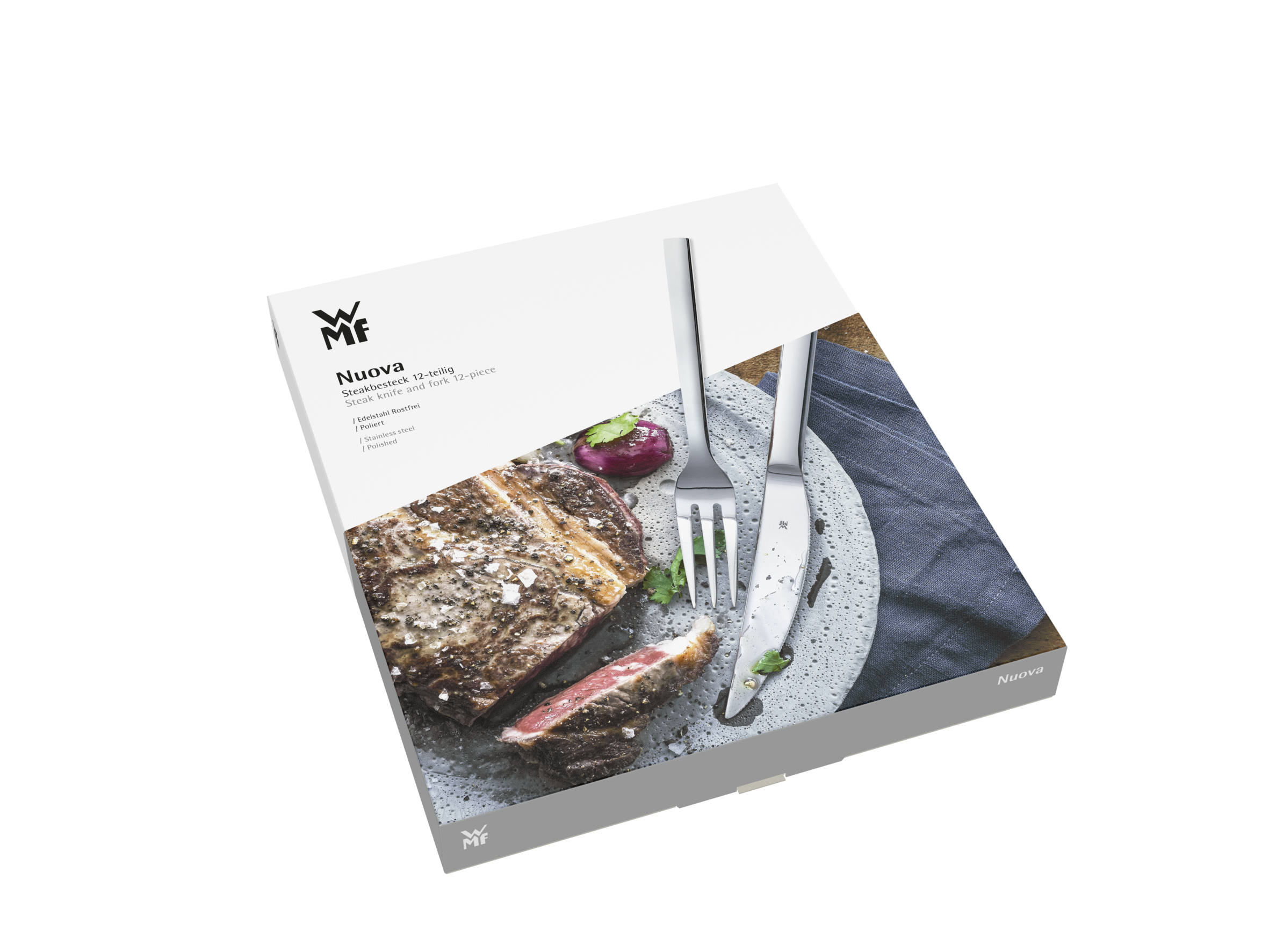 Pudełko z nożami do steków, stekiem i widelcem na stole.