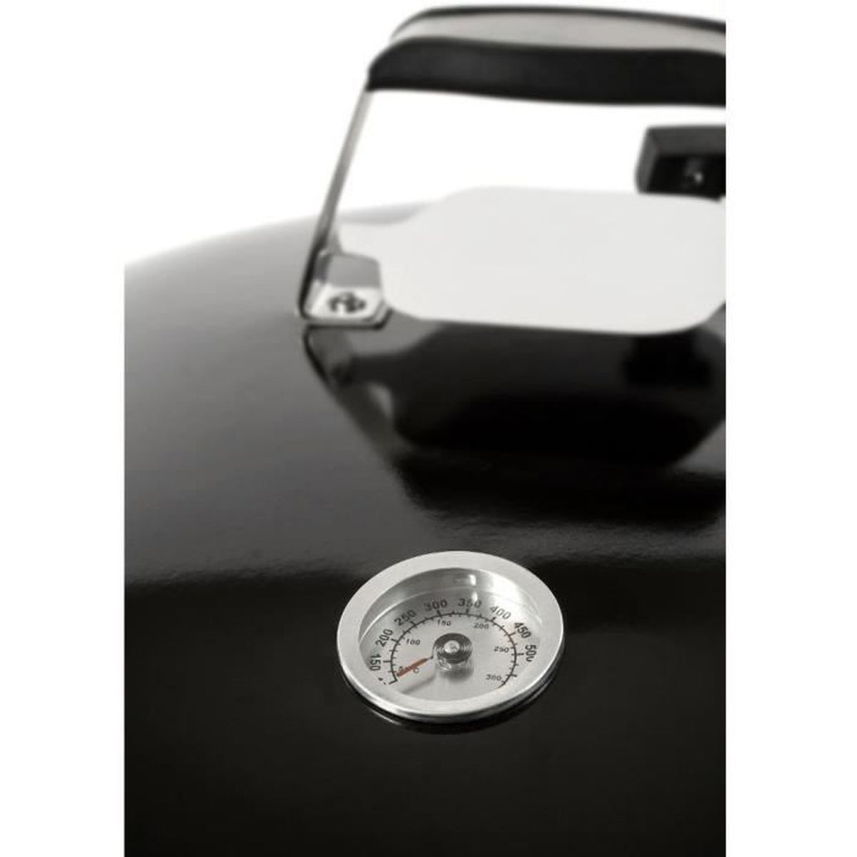 Close-up of a grill thermometer on a black lid. The thermometer shows the temperature.