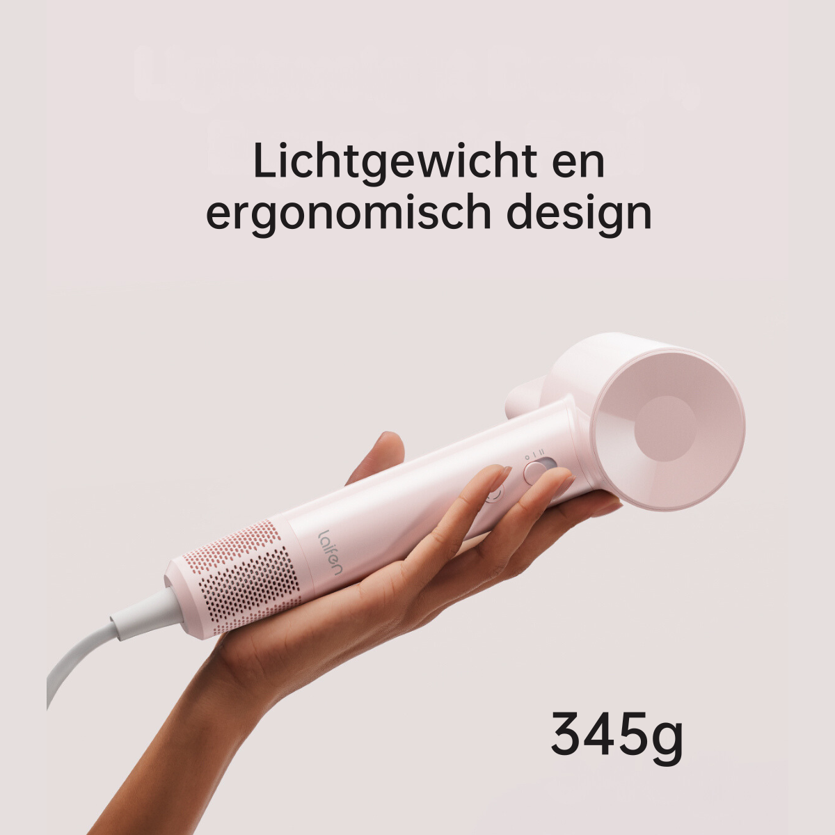 Dłoń trzymająca różową suszarkę do włosów. Tekst mówi 'Lekki i ergonomiczny design' oraz '345g' na dole.