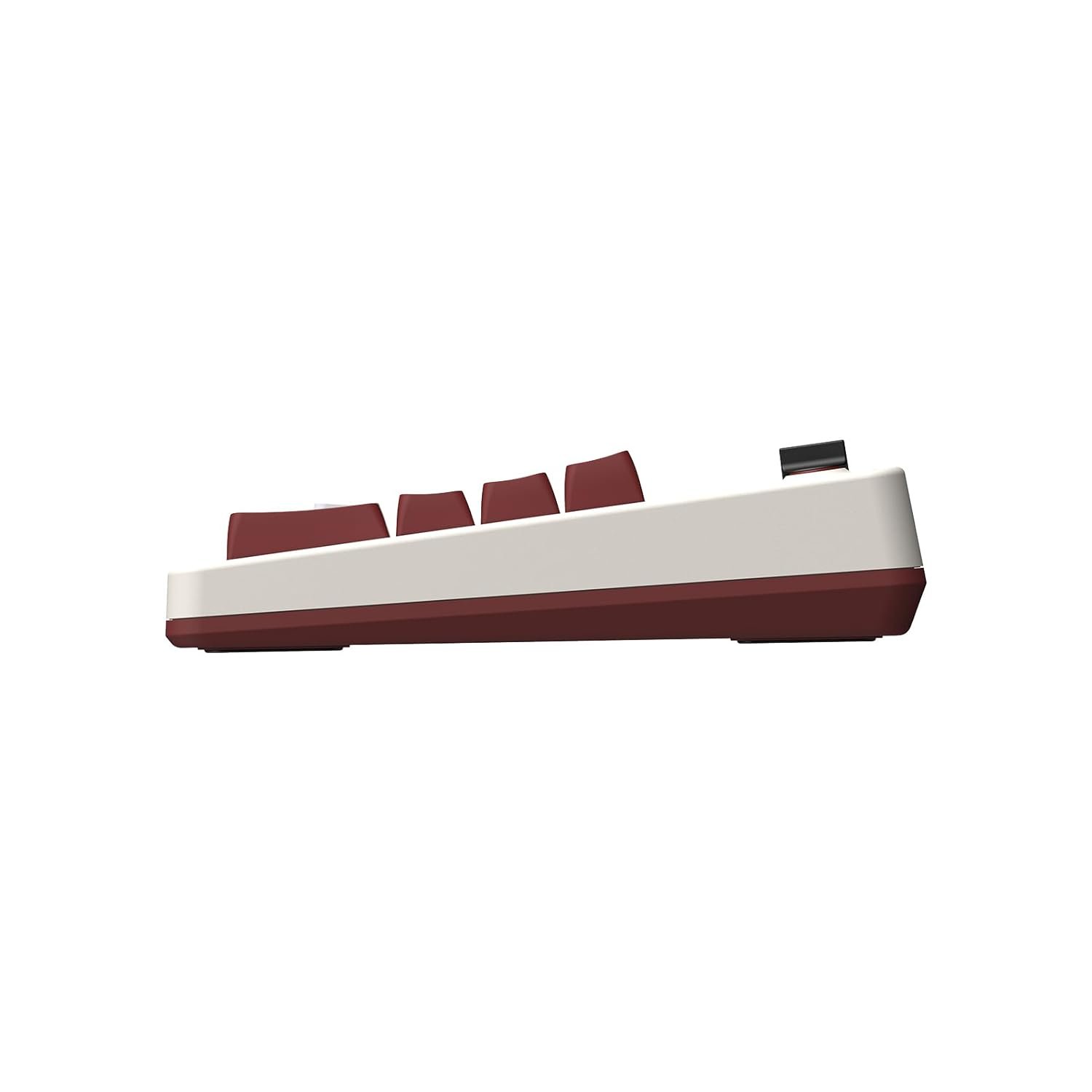 Widok z boku beżowej i bordowej klawiatury mechanicznej. Klawisze są bordowe.