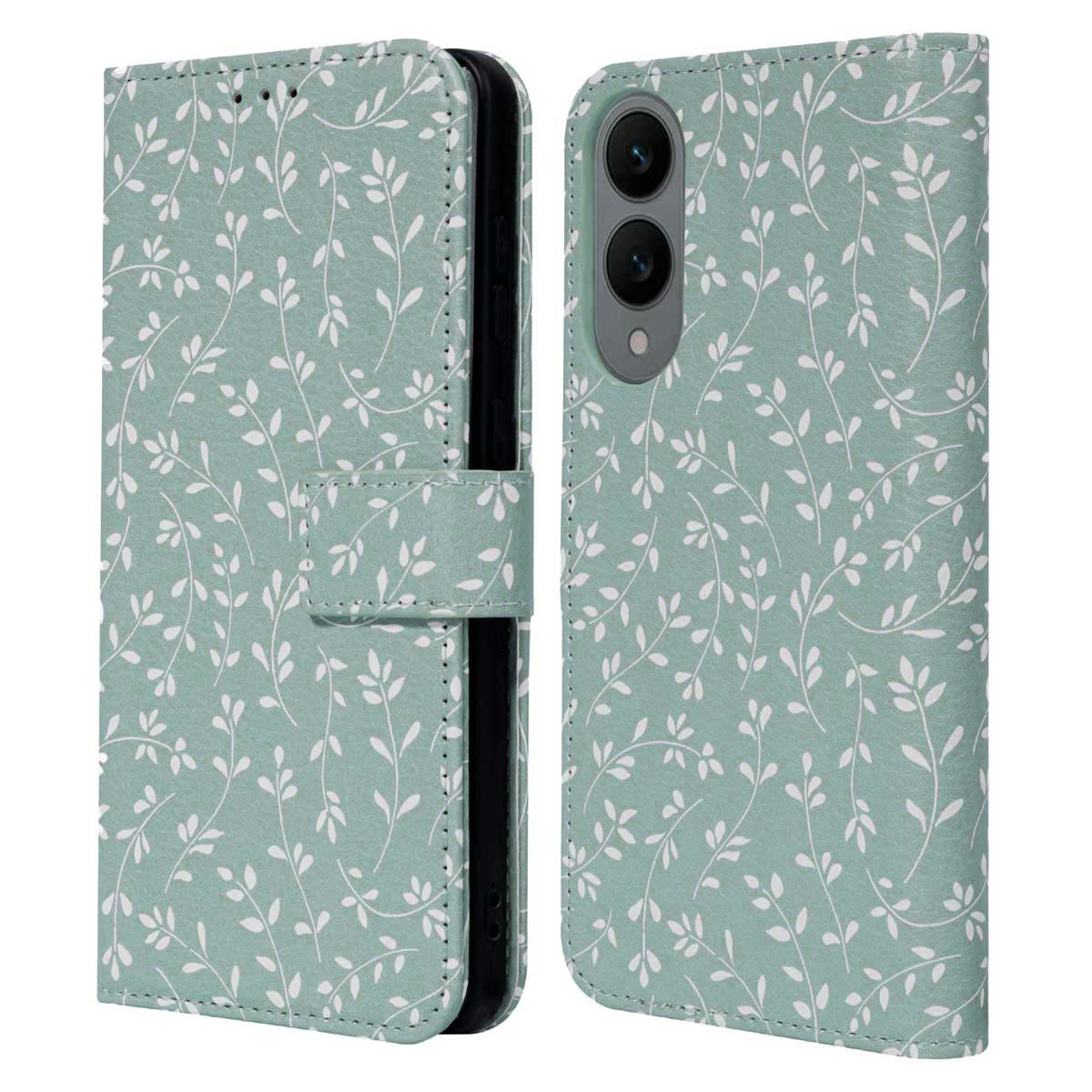 Étui de téléphone vert menthe avec motif de feuilles blanches, ouvert montrant le téléphone. Fermeture magnétique.