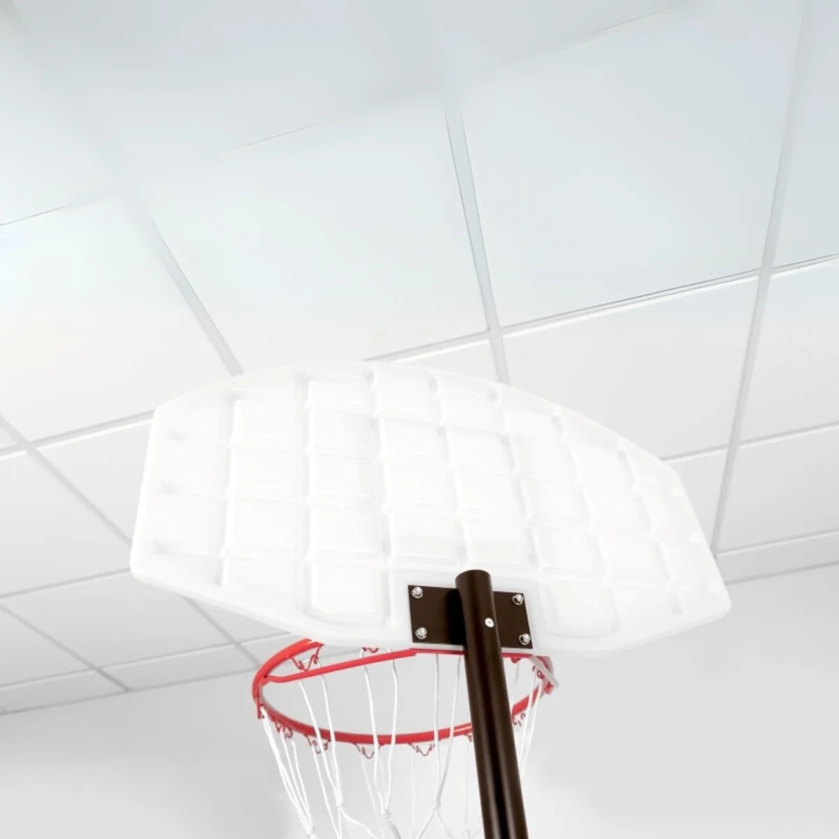 A basketball hoop from below. White backboard and red rim.