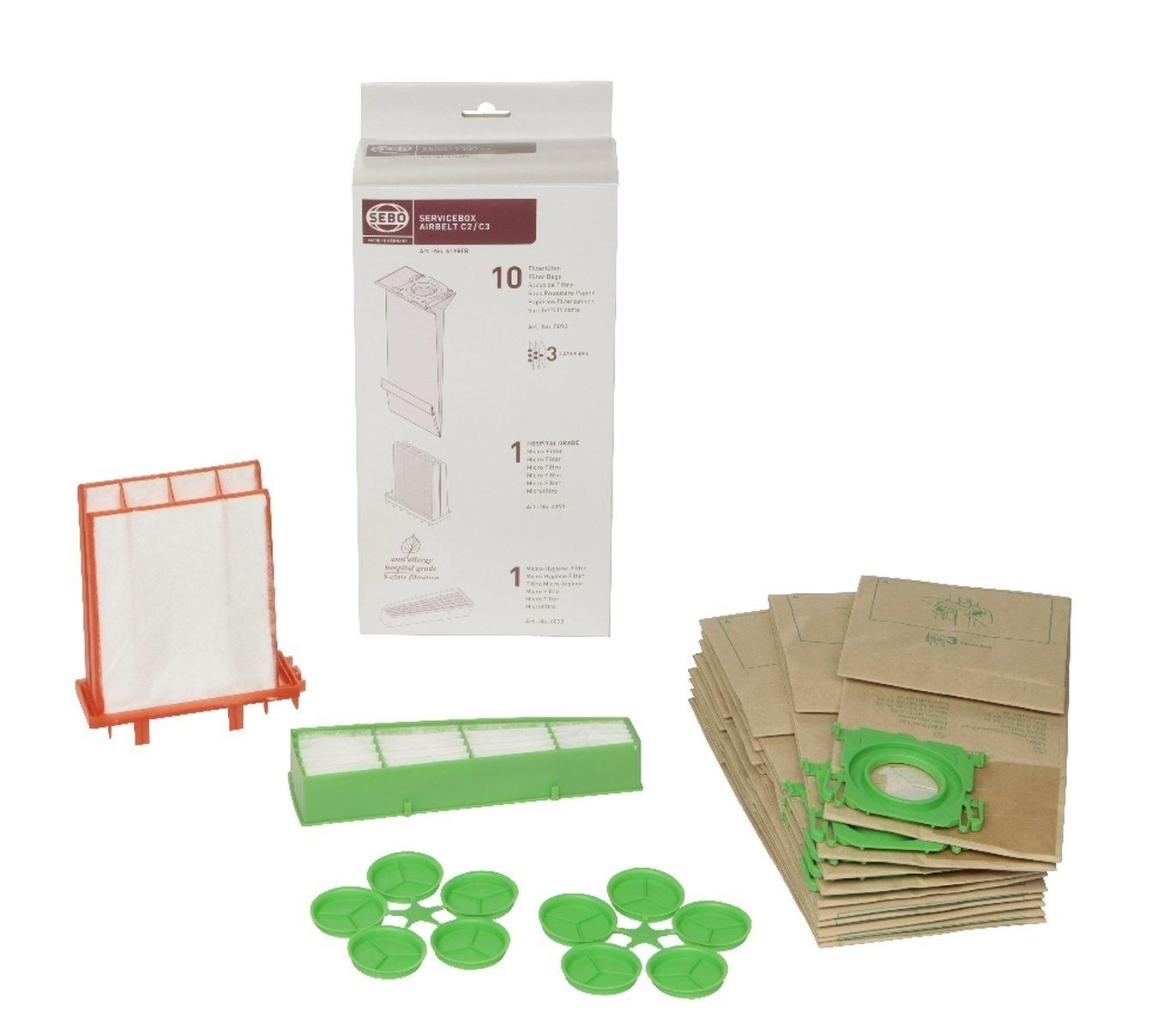 Accessori per filtro per aspirapolvere, inclusi filtri e sacchetti filtro, disposti su una superficie bianca.