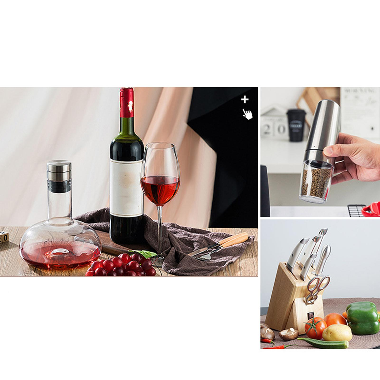 Arrangement mit Wein, Dekanter, Trauben und Messern. Pfeffermühle und Küchenmesser.