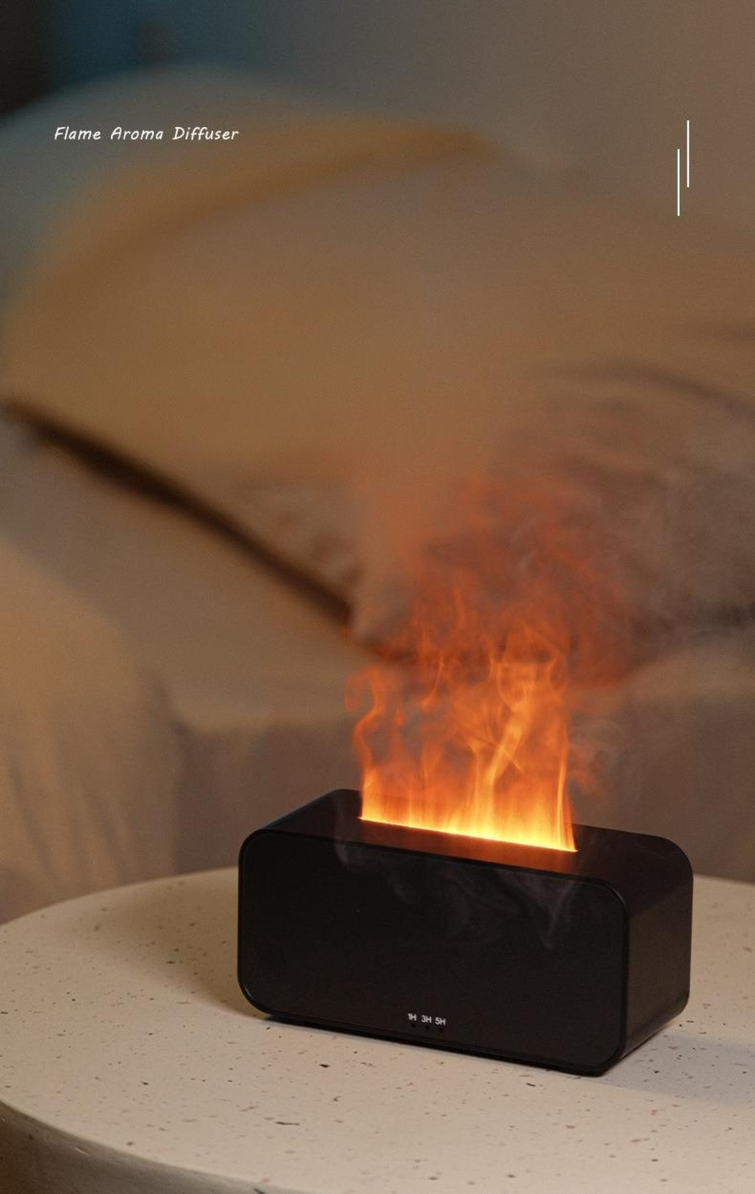 Schwarzer Flammen-Aroma-Diffusor mit Flammeneffekt. Er steht auf einem weißen Tisch.