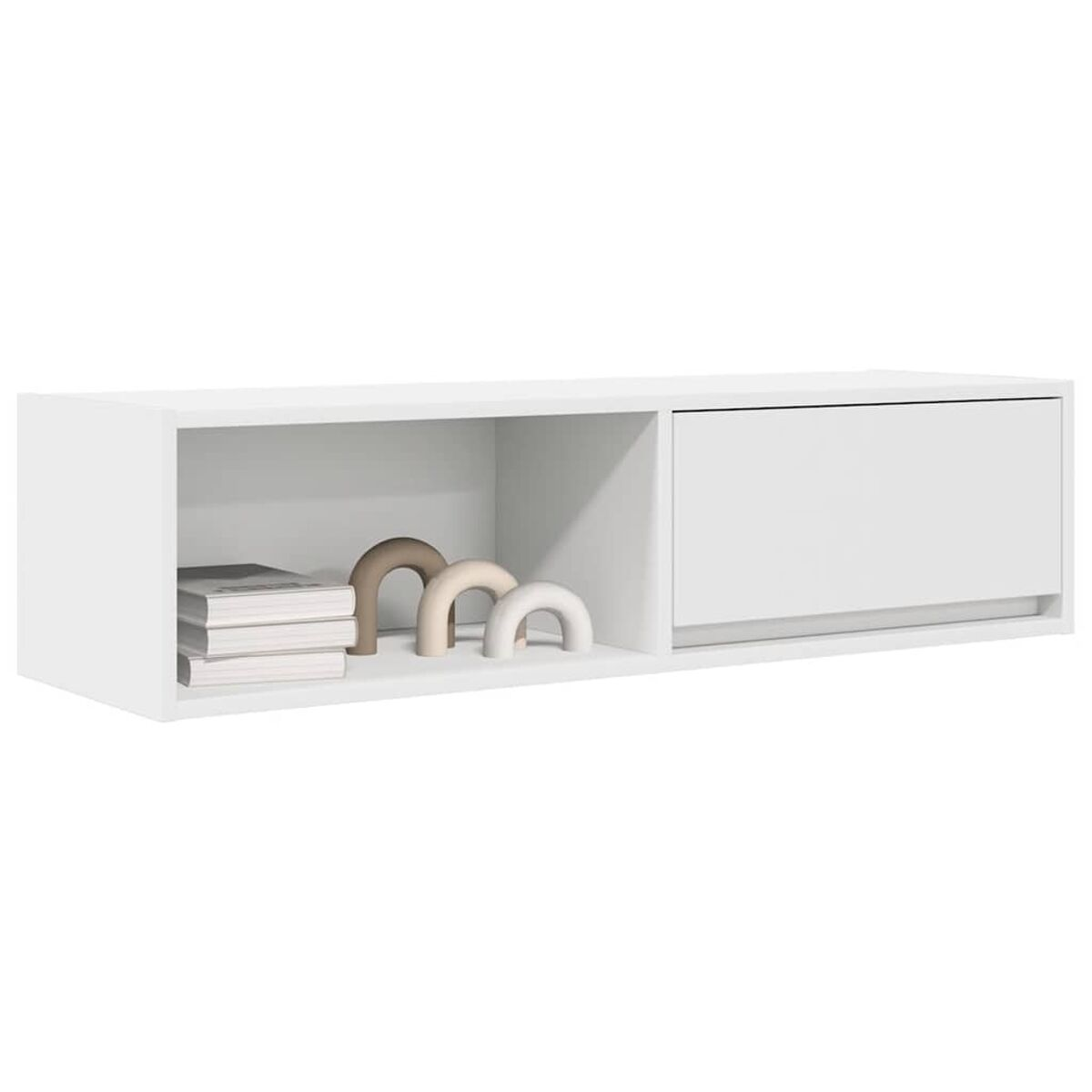 Ein weißer, an der Wand befestigter Schrank mit Bücher und Deko, und einer Schublade.