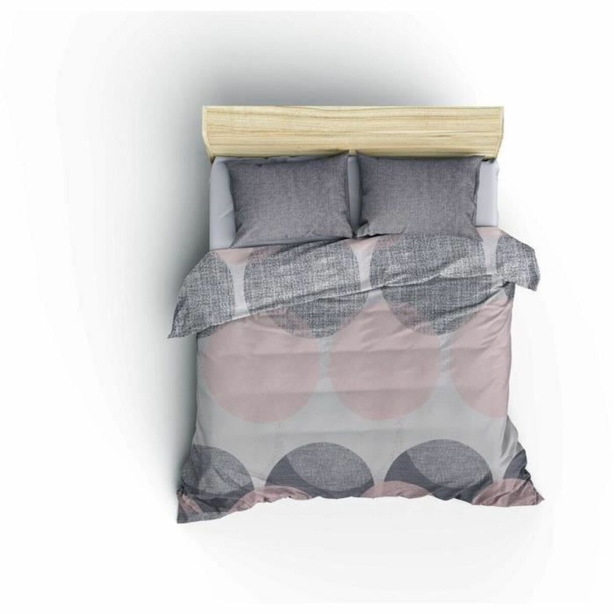 Bettwäsche mit rosa und grauen Kreisen auf weißem Hintergrund. Das Bett wird von oben gesehen.