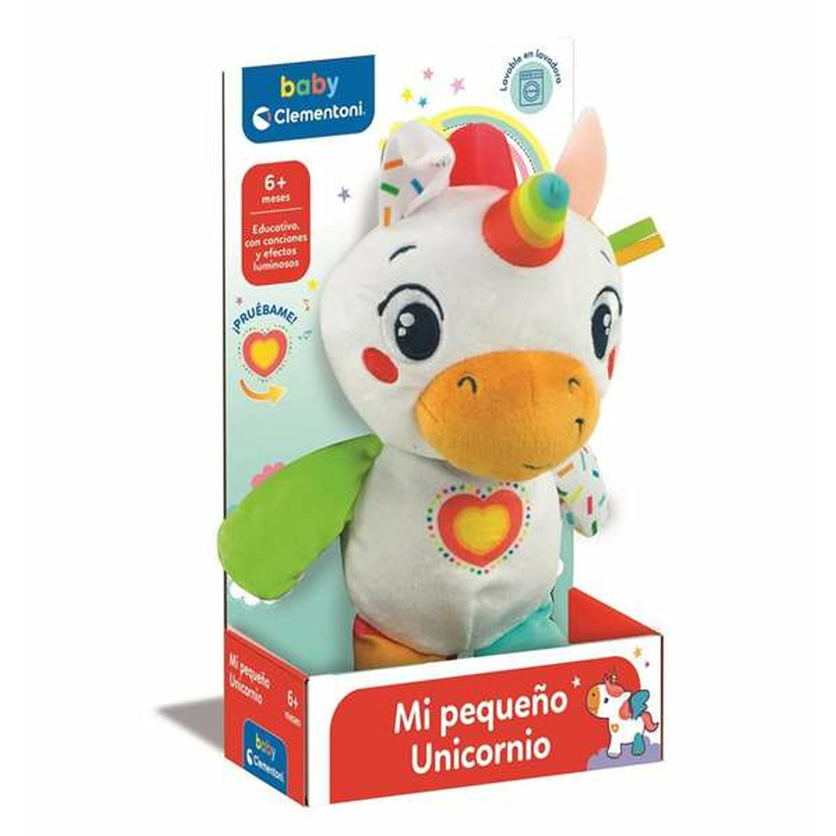 Un peluche unicorno bianco in una scatola, con accenti arcobaleno e un cuore sul petto.