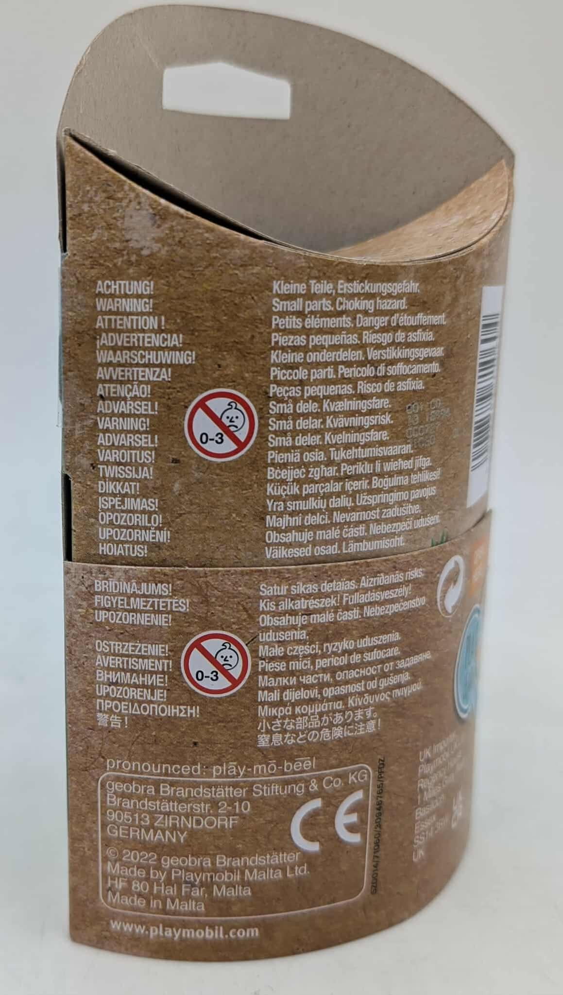 Tył pudełka z zabawkami Playmobil z tekstem w wielu językach, w tym ostrzeżeniami.