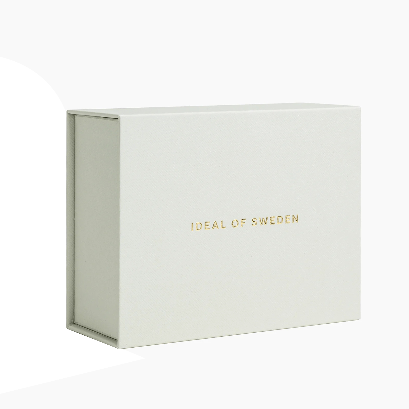 Una scatola bianca con la scritta 'IDEAL OF SWEDEN' in oro. La scatola ha un coperchio.