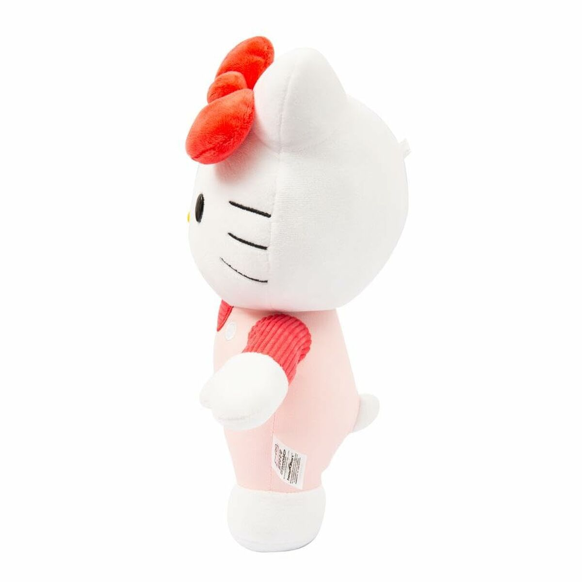 Seitenansicht eines Hello Kitty Plüschtiers, trägt rosa Latzhose und rote Schleife.