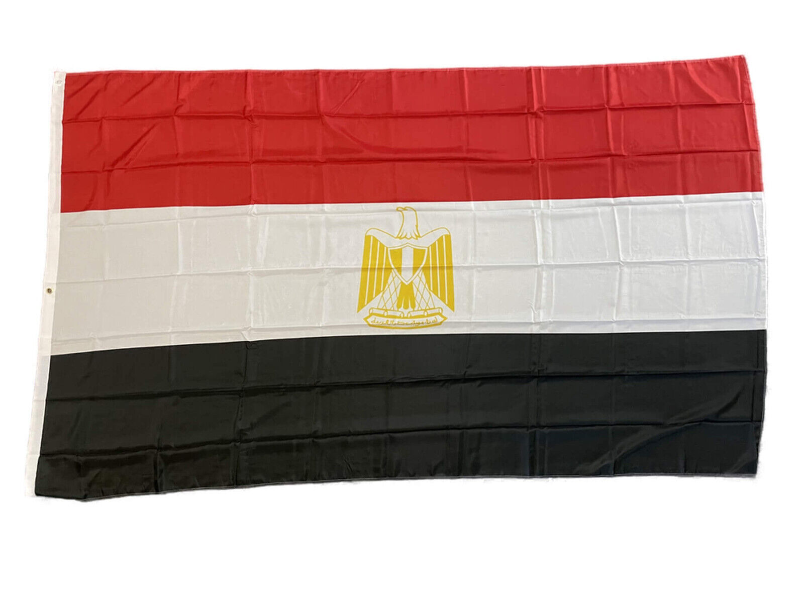 Ägyptische Flagge mit roten, weißen und schwarzen horizontalen Streifen und einem goldenen Adler in der Mitte.
