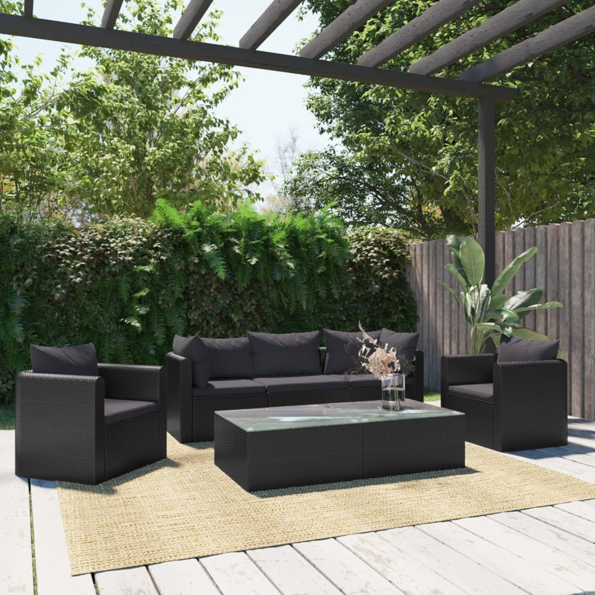 Outdoor-Terrassenset mit schwarzen Korbmöbeln, darunter ein Sofa, zwei Stühle und ein Couchtisch.