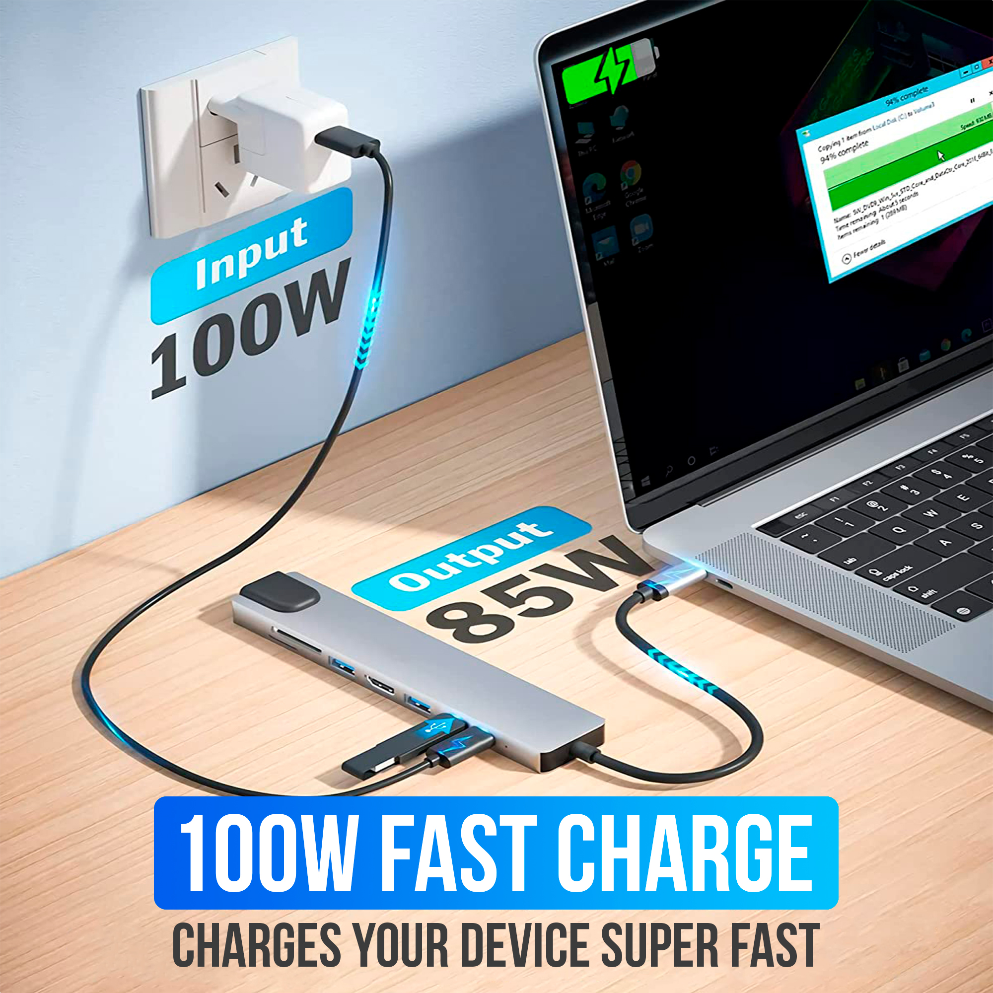 Un ordinateur portable se charge avec un hub connecté. Le hub est connecté à une prise murale. Le texte indique une charge rapide à 100W.