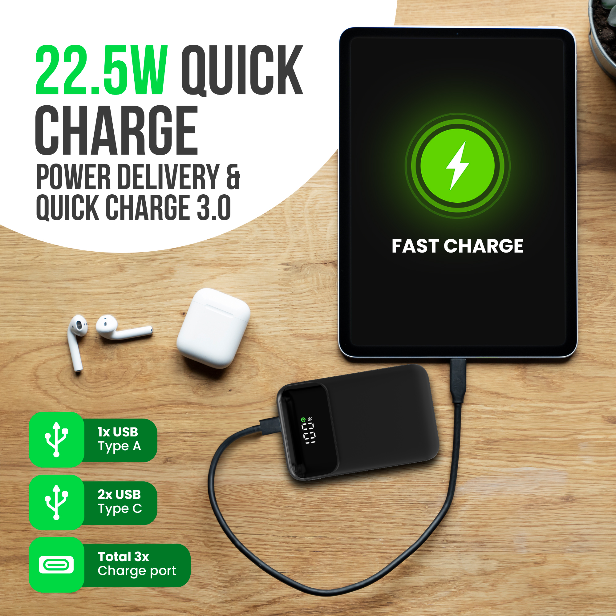 Tablette et powerbank sur une table en bois. Écouteurs et ports de charge également visibles. Le texte dit 'Quick Charge'.