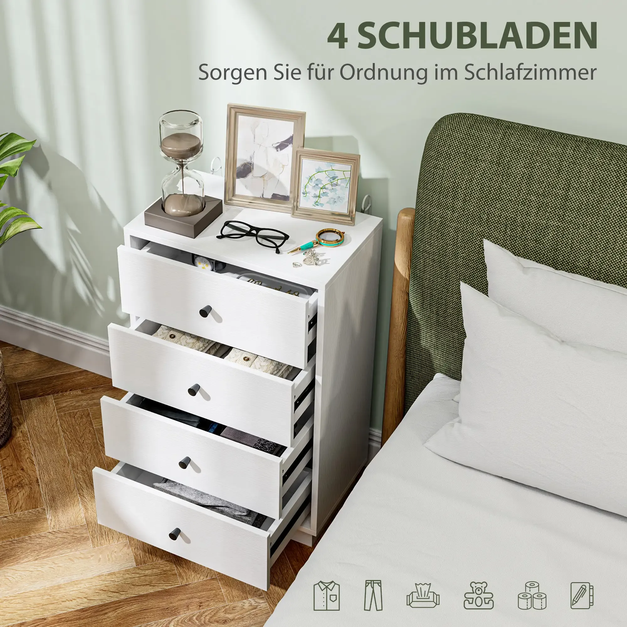 Ein weißer Nachttisch mit vier offenen Schubladen steht neben einem Bett in einem Schlafzimmer.
