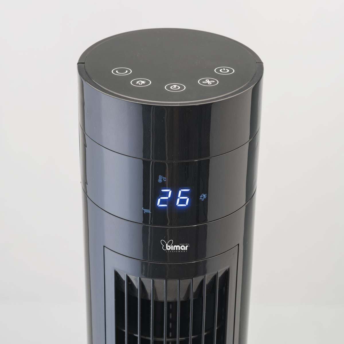 A close-up of the top of a black tower fan with a digital display showing the temperature.
