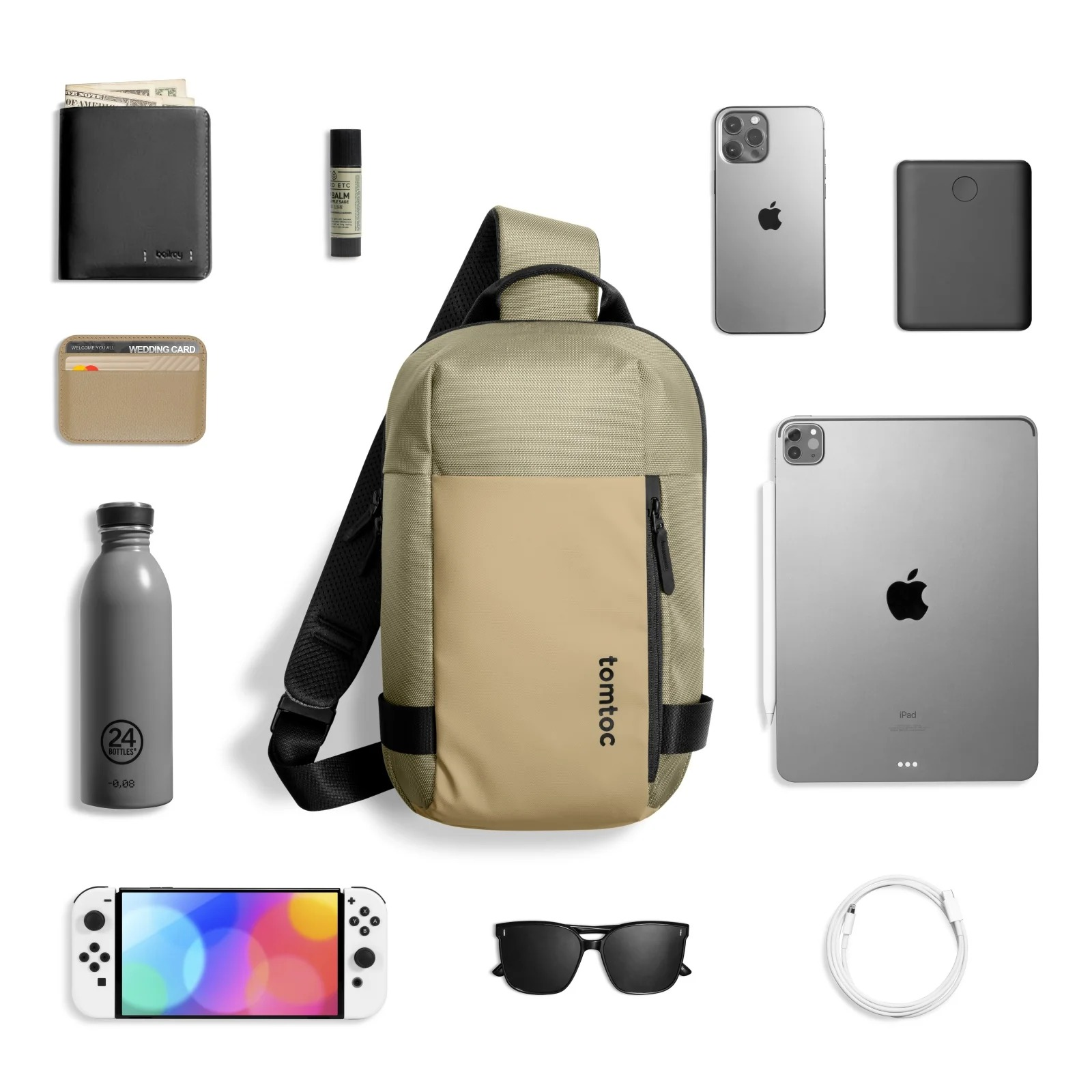 Torba, portfel, okulary, telefon, tablet, butelka wody, ładowarka i Nintendo Switch.