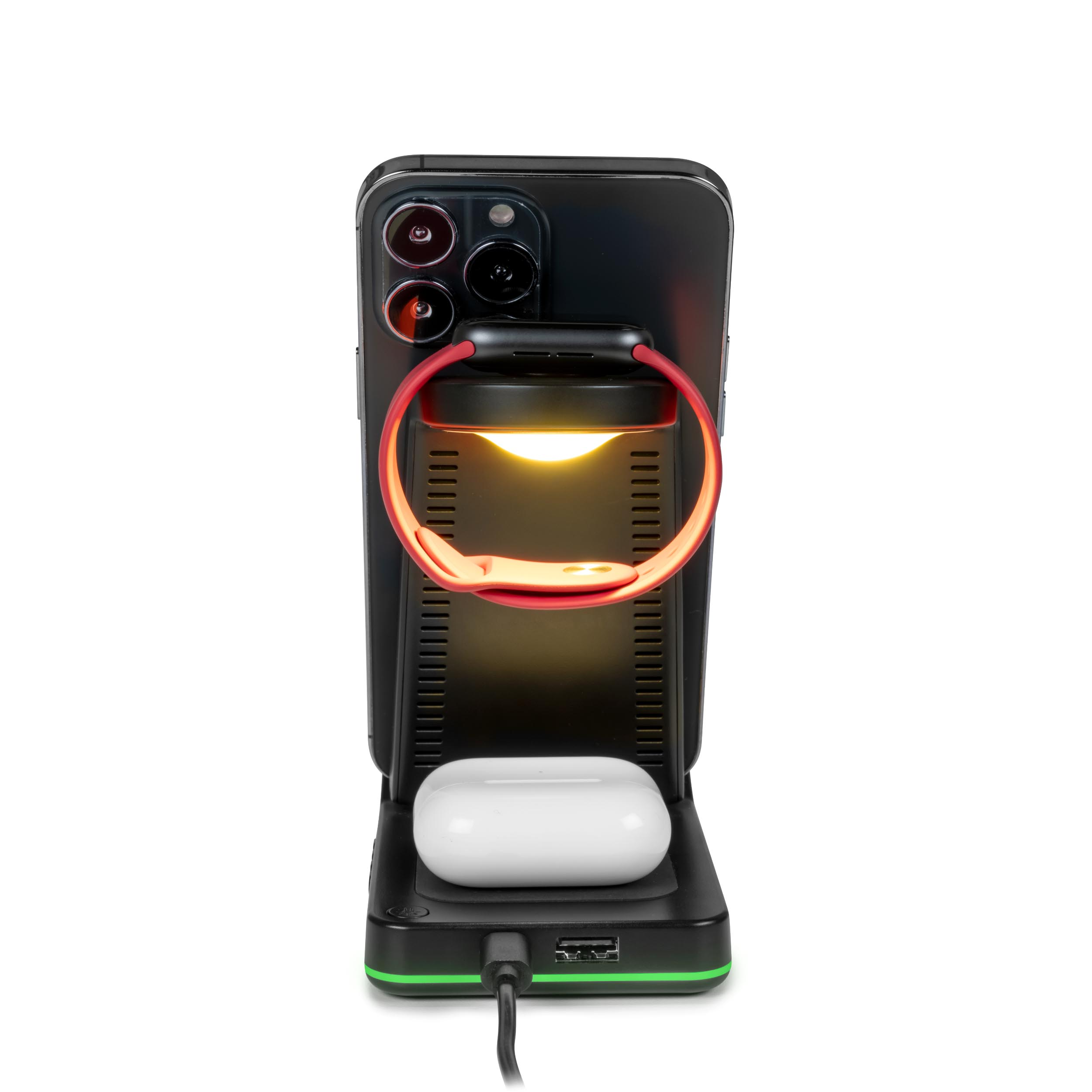 Stacja ładująca z telefonem, słuchawkami i smartwatchem. Telefon jest podświetlony, a zegarek ma czerwony pasek.