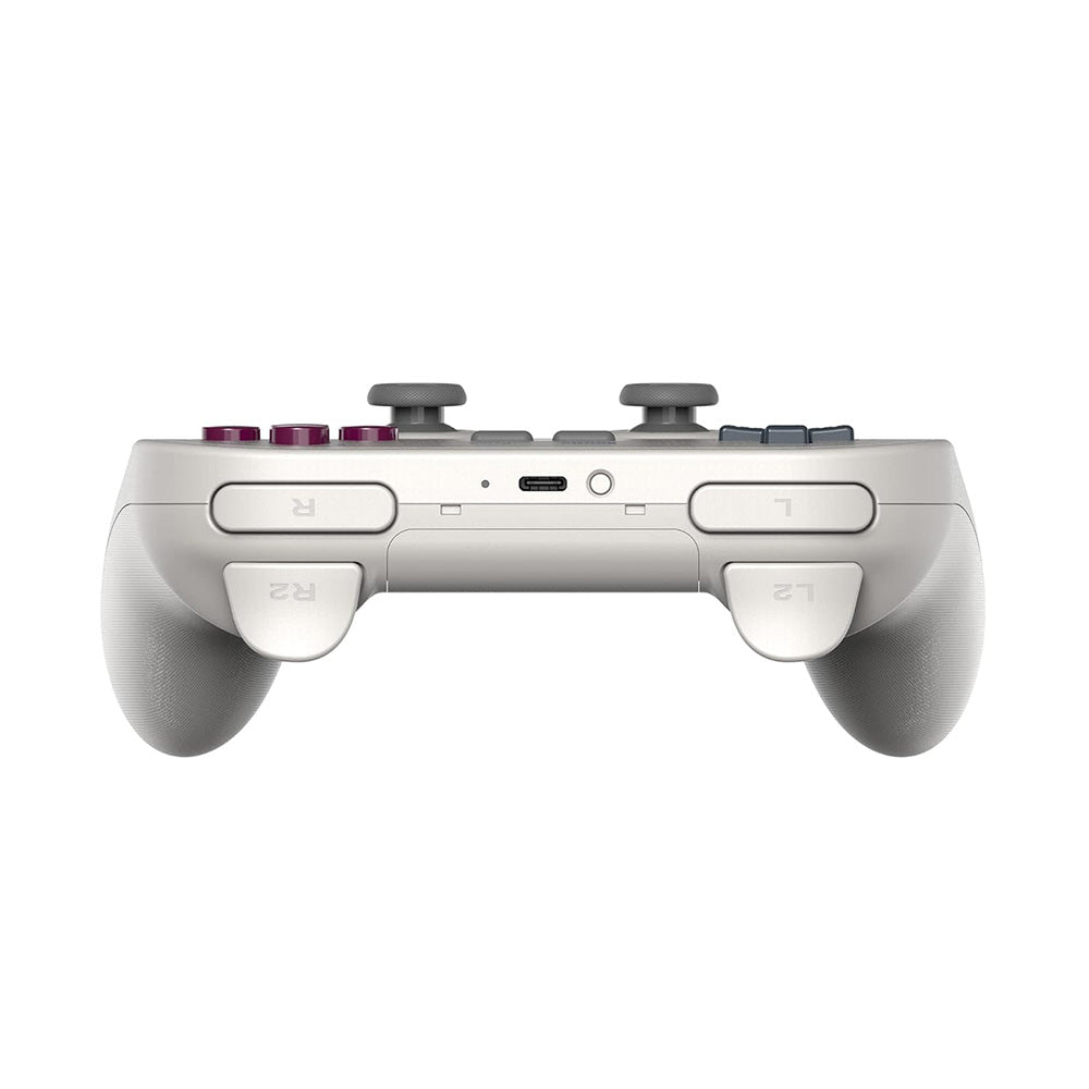 Un mando de juego gris claro con botones y joysticks, visto desde arriba.