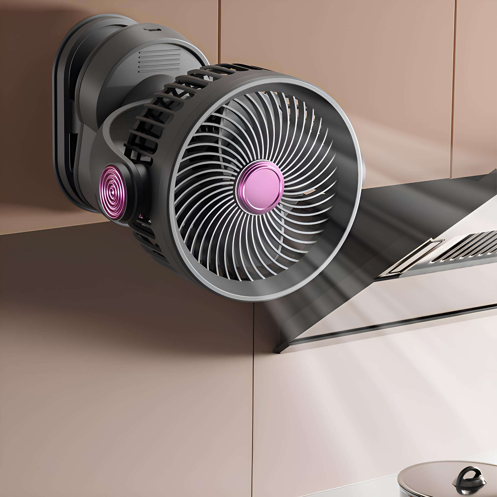 Ein grau-rosa Ventilator ist an einer Wand montiert. Der Ventilator befindet sich vor einer Dunstabzugshaube.