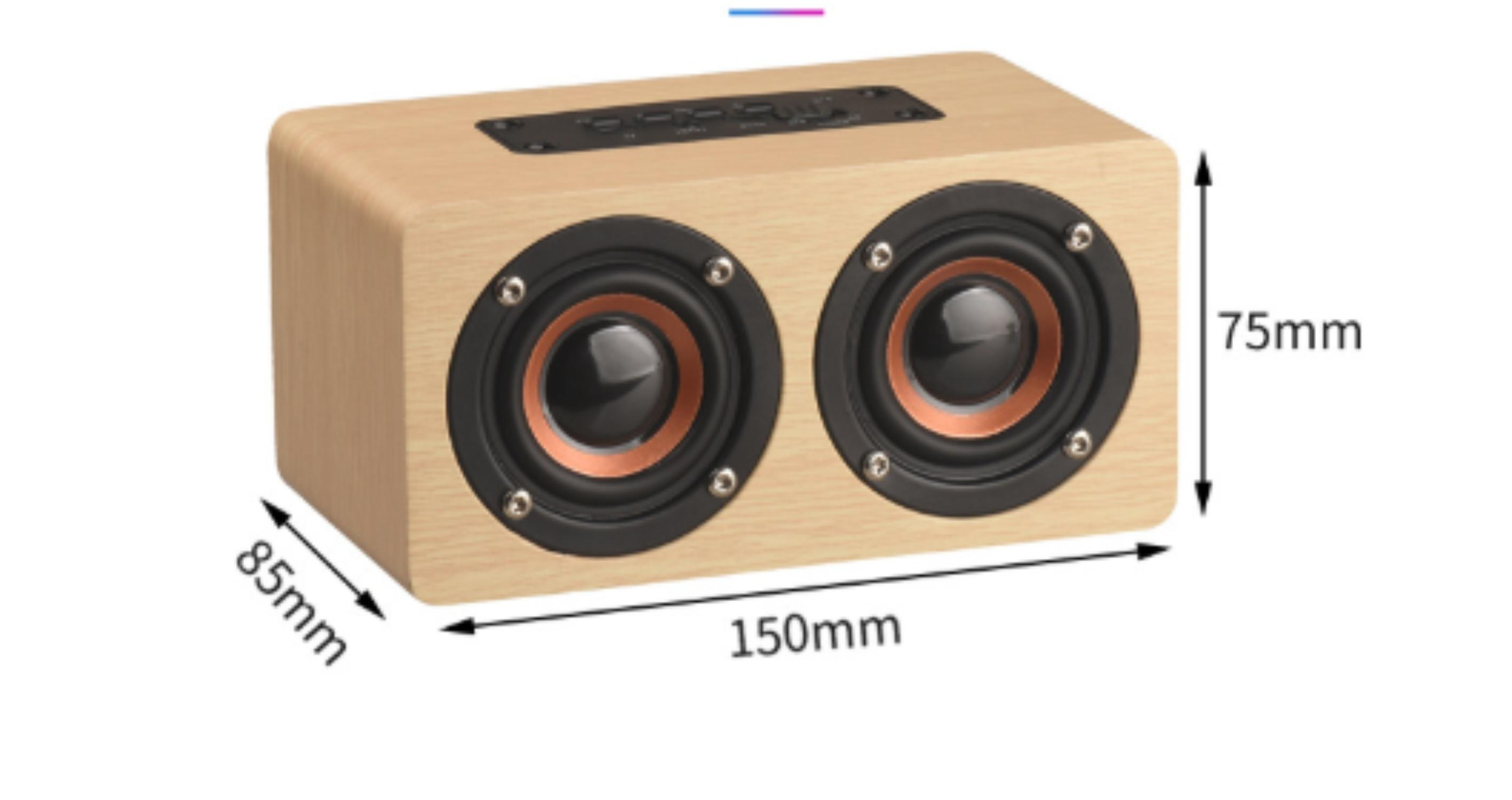 Holzlautsprecher mit zwei schwarzen Lautsprechern und Kupferringen. Abmessungen sind 150x85x75mm. Bedienelemente befinden sich oben.