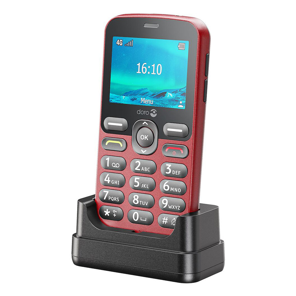 Czerwony telefon Doro pokazuje 16:10 na ekranie, w czarnej ładowarce. Przyciski widoczne. Symbol 4G w lewym górnym rogu.