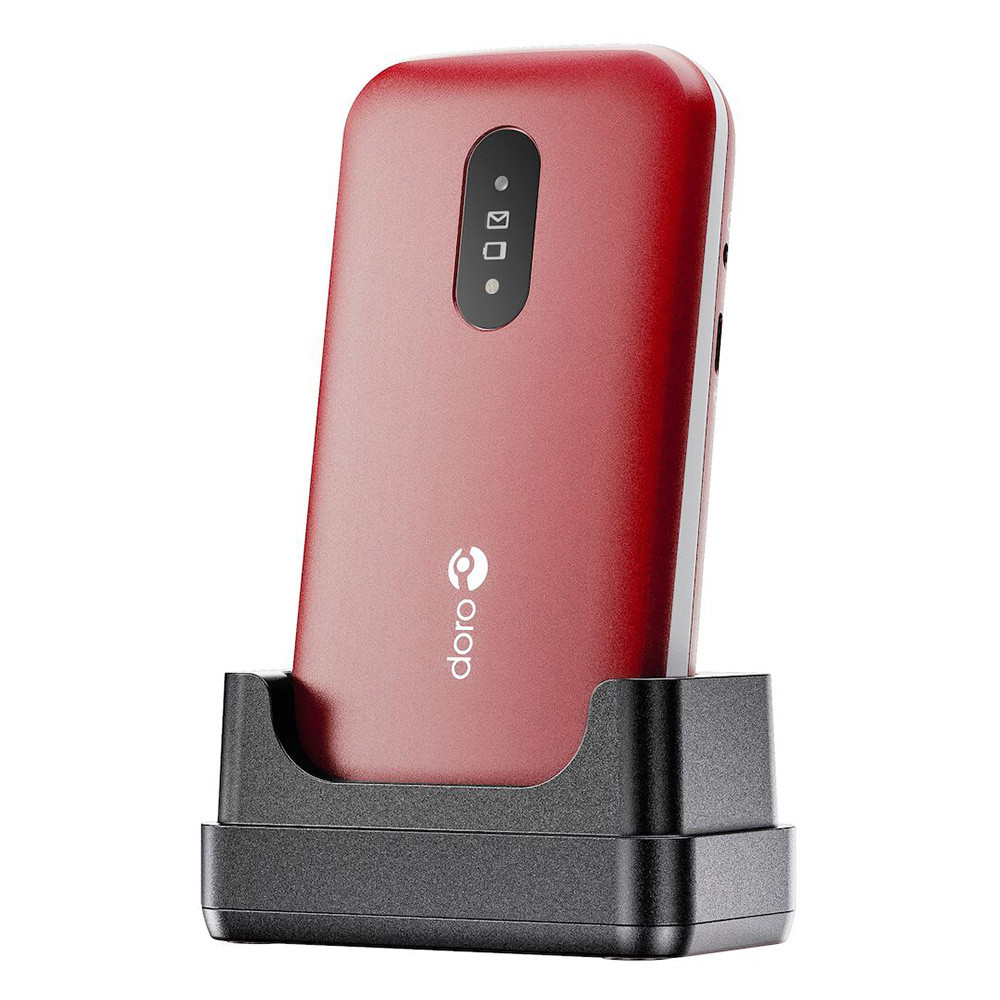 Czerwony telefon Doro w czarnej stacji ładującej. Telefon ma ekran z ikonami i logo Doro. Tło jest białe.