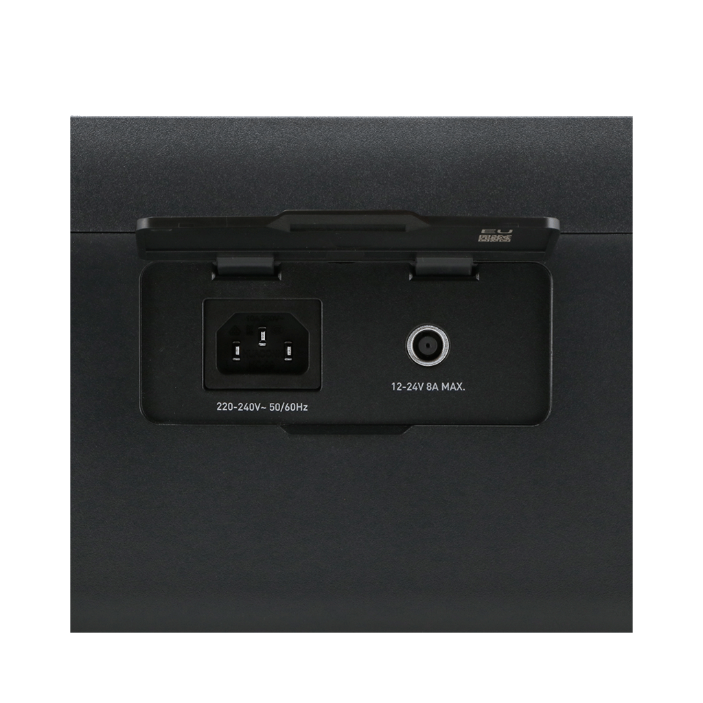 Black panel with power input, circular port, and labels. The panel is part of a larger, black device.