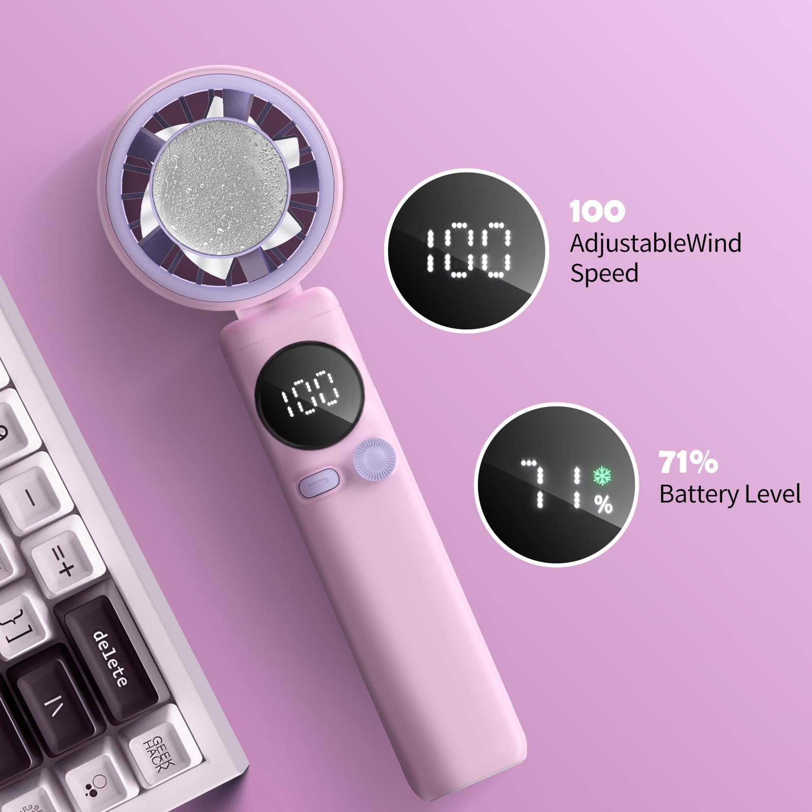 Ein rosa Handventilator zeigt Windgeschwindigkeit und Akkuladestand. Eine Tastatur befindet sich unten links auf rosa Untergrund.