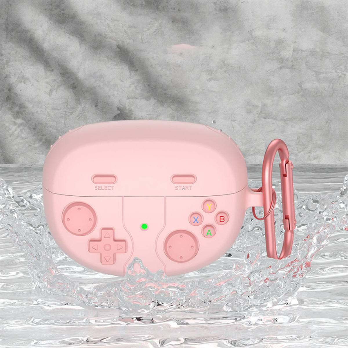 Ein rosa Gehäuse in Form eines Gamecontrollers mit Knöpfen. Es hat einen Metallclip an der Seite. Wasser spritzt um das Gehäuse herum.