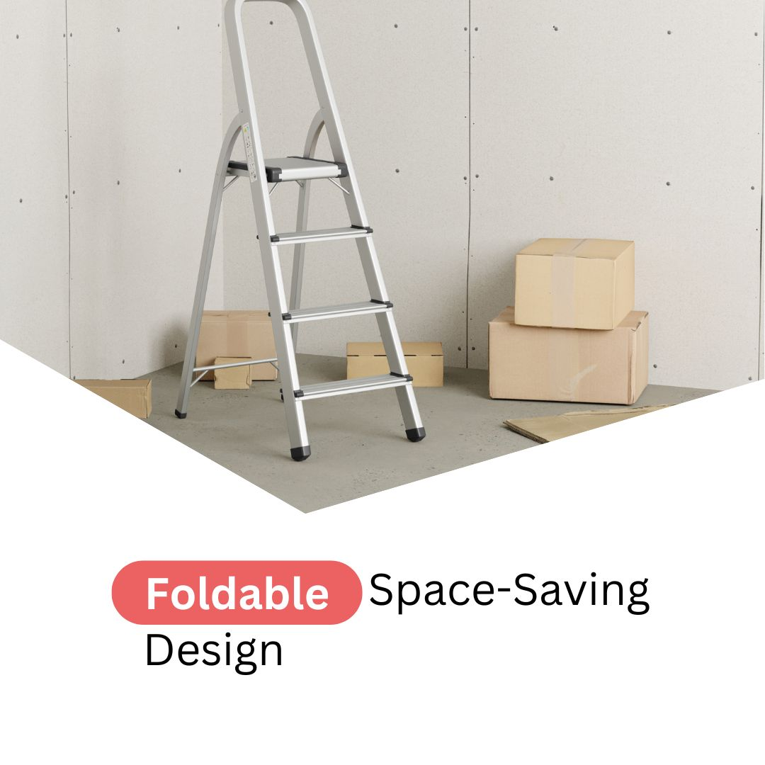 A silver folding ladder stands near cardboard boxes in a room. The wall is light gray. The floor is concrete.