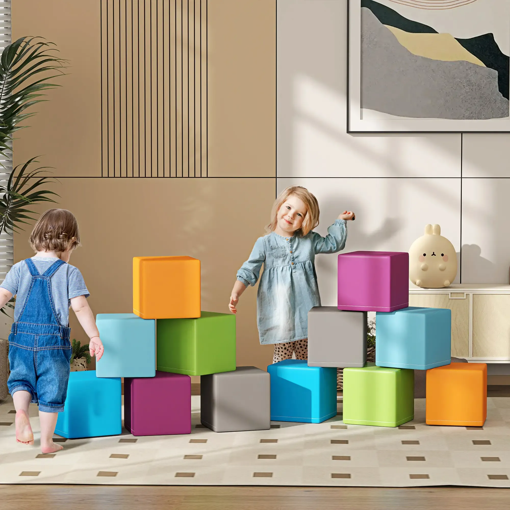 Zwei Kinder spielen mit bunten Blöcken. Ein Stapel Blöcke steht in der Mitte des Raumes. Kunstwerke und ein dekoratives Objekt sind an der Wand.