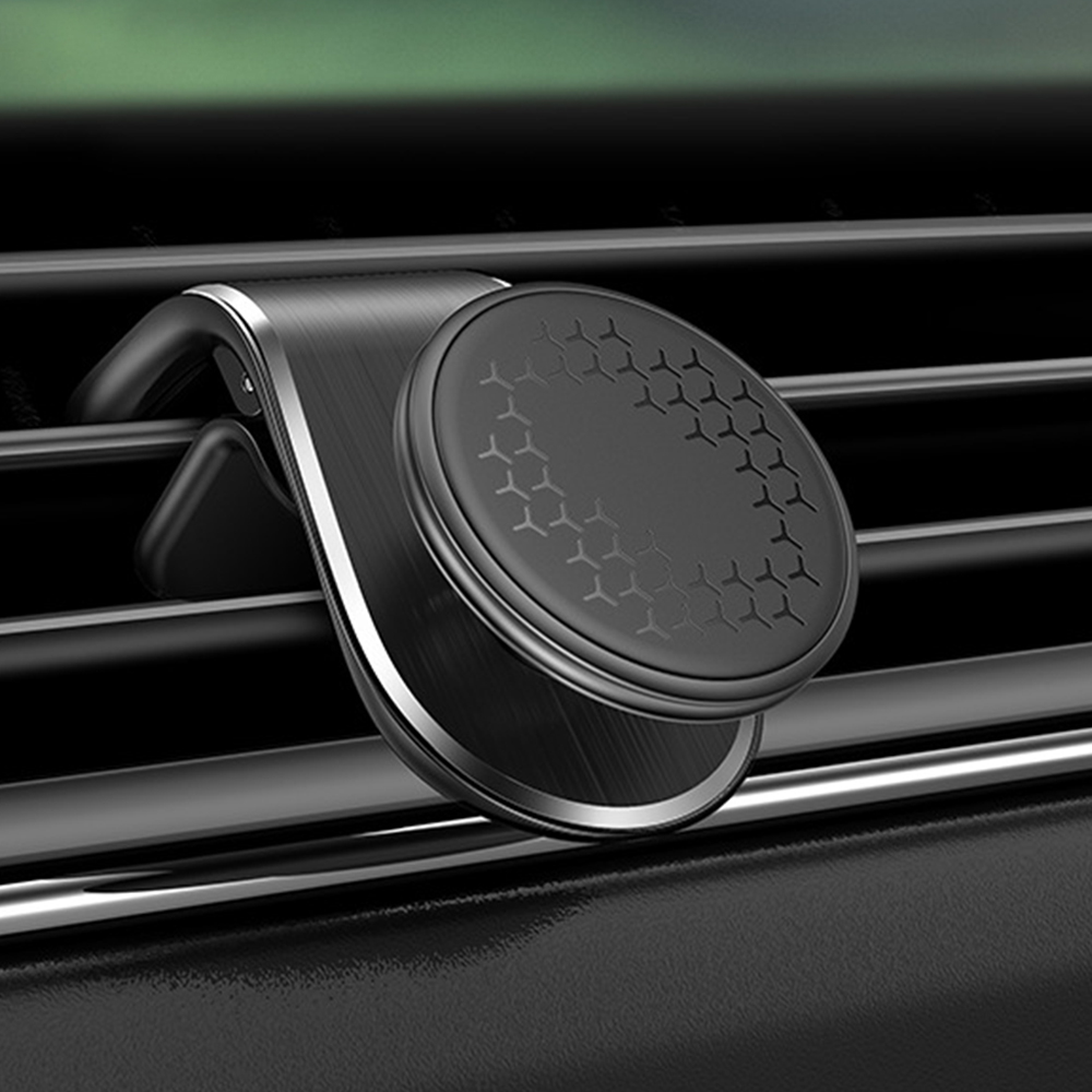 Ein schwarzer Handyhalter für die Lüftung im Auto. Er ist rund, hat eine gemusterte Oberfläche und metallische Akzente.