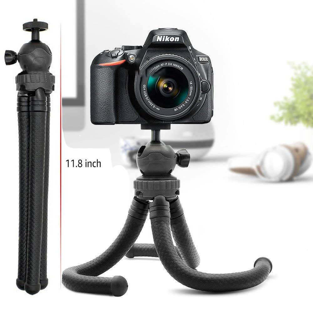 Eine schwarze Nikon D5600 Kamera ist auf einem flexiblen schwarzen Stativ montiert. Das Stativ ist 11,8 Zoll hoch. Der Hintergrund ist unscharf.