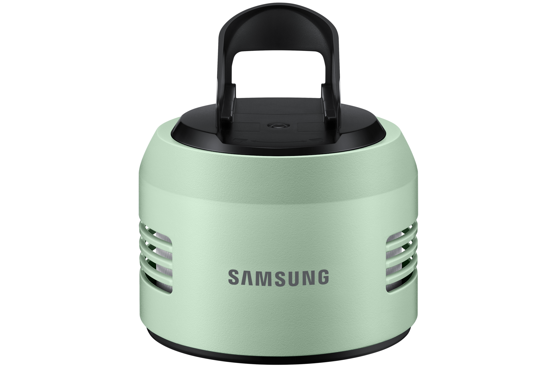 Ein hellgrüner Samsung-Lautsprecher. Er hat eine schwarze Oberseite mit einem Griff. Der Lautsprecher hat horizontale Lüftungsschlitze und einen schwarzen Sockel.