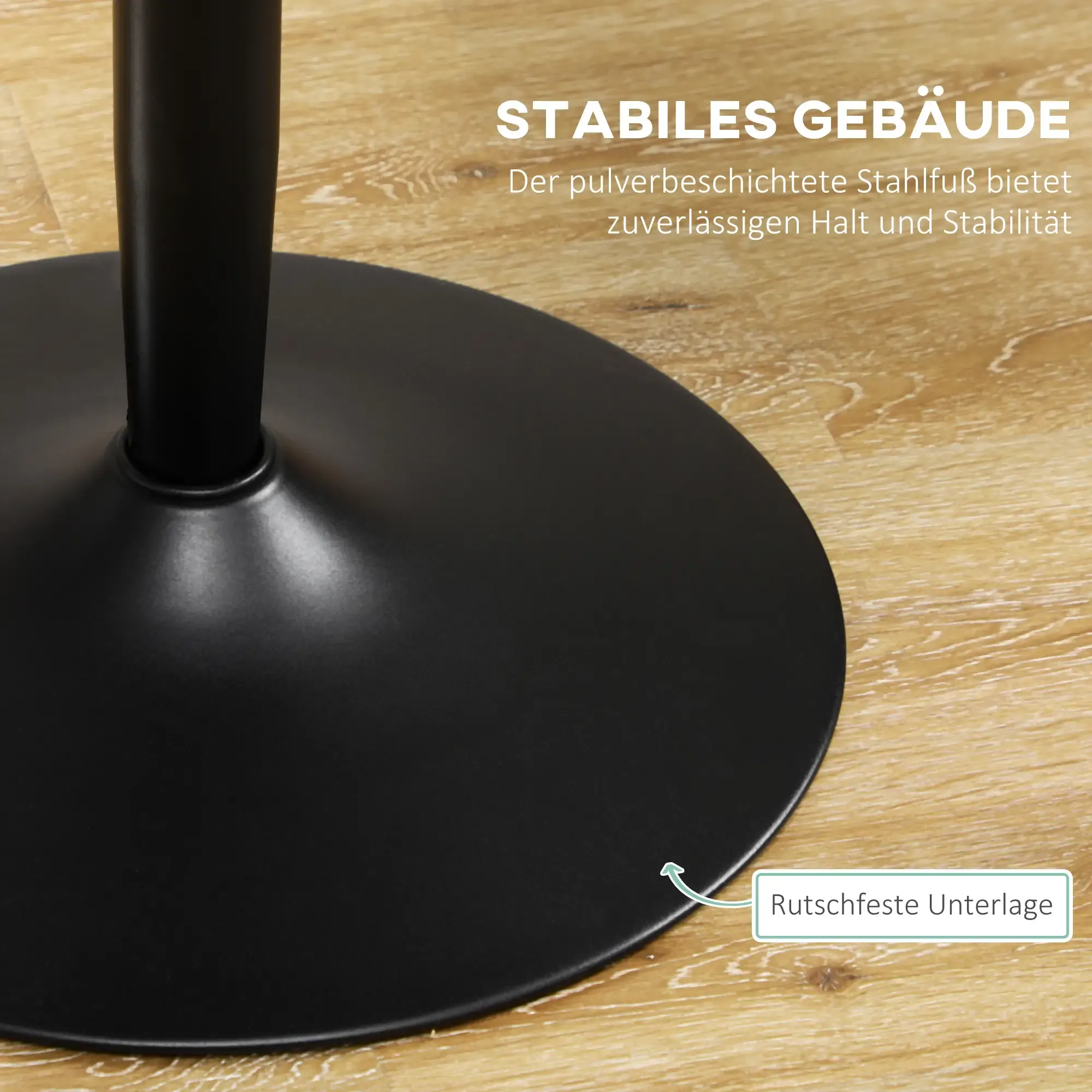 Schwarze, kreisförmige Basis eines Tisches. Ein schwarzer Pfosten erhebt sich von der Basis. Es steht auf einem Holzboden.